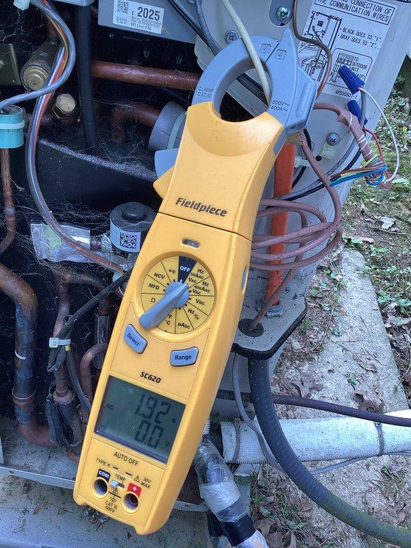 Completed basic monthly heating maintenance on CCHP system. Inspected blower assembly and squirrel cage fan, noting dust accumulation on metal blades and housing. Examined ductwork connections and foil insulation for proper sealing. Used Fieldpiece SC620 clamp meter to verify electrical readings on refrigerant lines, recording measurements of 132 and -106. Assessed copper tubing showing oxidation and corrosion discoloration. Verified all refrigerant line connections, wiring bundles, and control board operation. System operational upon completion of maintenance inspection.