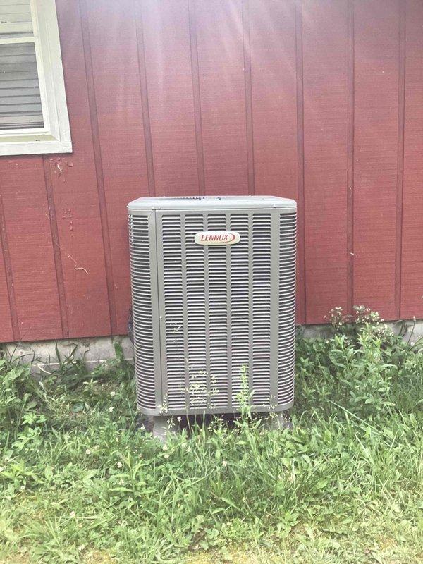 Responded to no-cooling complaint on Lennox residential air conditioning system. Upon arrival, found outdoor unit condenser fan motor inoperative; manually started fan motor but system still failed to produce cooling. Inspected electrical components and capacitor in control panel, documented existing dual-run capacitor configuration and wiring connections for diagnostic purposes.