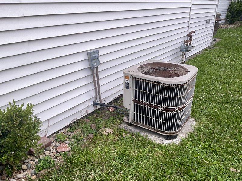 Conducted comprehensive evaluation of existing HVAC system for full replacement estimate. Unit assessed as 24+ years old with significant deterioration including rusted components, refrigerant leaks, and end-of-service-life condition. Documented equipment specifications and site conditions with photographic evidence showing exterior condensing unit on concrete pad with weathered housing, corroded fan grille, and compromised refrigerant lines. Provided complete system replacement recommendations and financing options to address failed equipment.