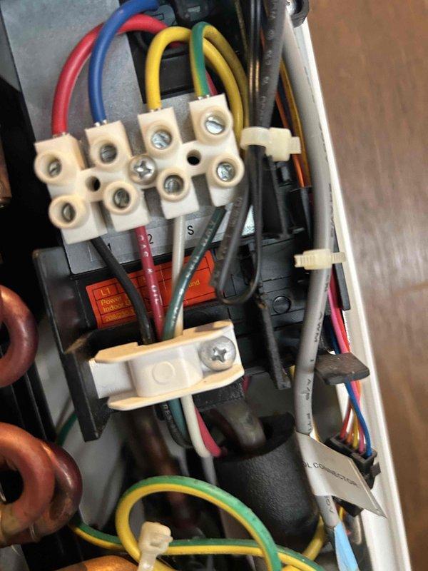 Responded to service call for mini split system with flashing error light indicator. Inspected electrical control panel and junction box wiring connections, terminal blocks, and safety components. Documented existing wiring configuration including power distribution terminals, control circuit connections, and grounding system for diagnostic purposes.
