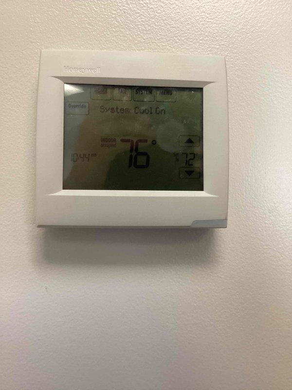 Responded to no-cooling complaint for front office air conditioning system. Upon arrival, found Honeywell programmable thermostat displaying system in cooling mode with indoor temperature at 76°F and setpoint at 72°F, outdoor temperature reading 94°F. Inspected outdoor condensing unit and verified equipment operation, checked electrical connections at disconnect box, and confirmed unit cycling properly. System restored to normal operation.