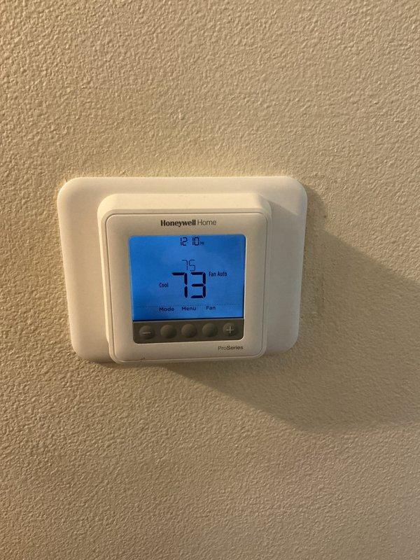 Completed annual basic cooling maintenance visit on residential HVAC system. Performed standard inspection procedures, verified thermostat operation showing 73°F ambient with 75°F setpoint and programmed schedule functionality, and inspected outdoor condensing unit accessibility. System operating within normal parameters at time of service.