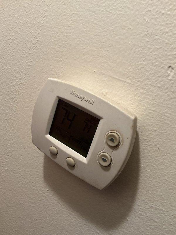 Completed comprehensive cooling maintenance on residential HVAC system, including inspection of Honeywell digital thermostat displaying proper operation at 57 degrees and thorough examination of outdoor condenser unit electrical components. All electrical connections, contactors, and wiring were inspected and found to be functioning within normal parameters, with unit showing typical weathering consistent with outdoor installation.
