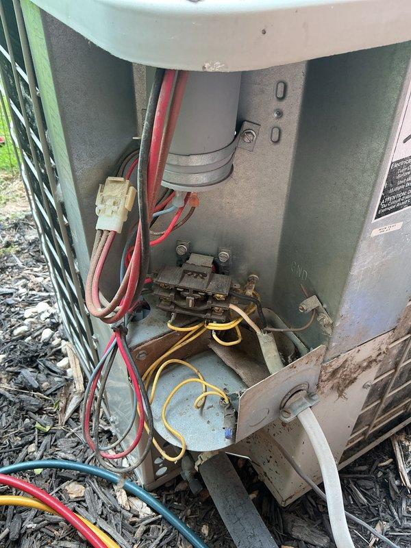 Completed comprehensive cooling maintenance on residential HVAC system, including inspection of Honeywell digital thermostat displaying proper operation at 57 degrees and thorough examination of outdoor condenser unit electrical components. All electrical connections, contactors, and wiring were inspected and found to be functioning within normal parameters, with unit showing typical weathering consistent with outdoor installation.