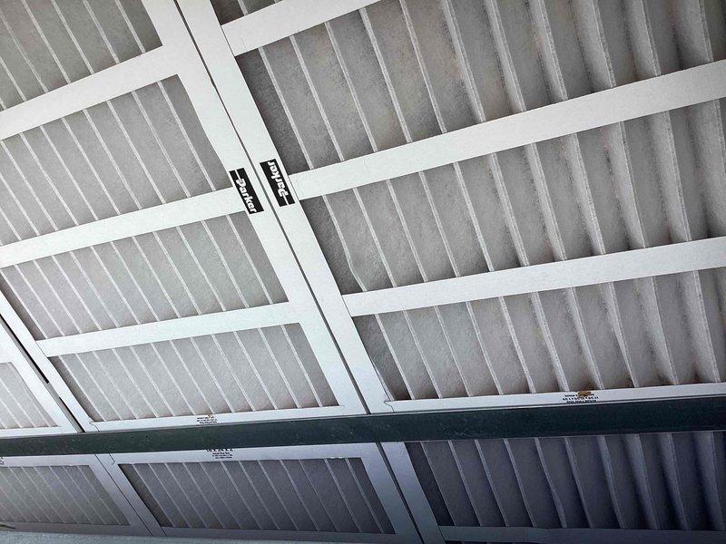 Conducted initial site assessment of commercial HVAC system installation at bowling facility. Documented replacement air filters with proper airflow directional markings and photographed ceiling-mounted ductwork and structural supports for warranty documentation purposes. Follow-up site visit scheduled to complete final inspection and coordinate with facility management regarding installation warranty requirements.