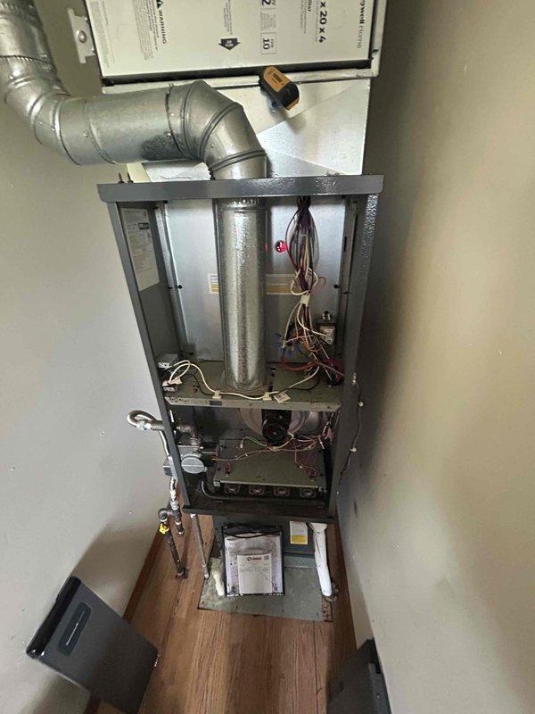 Responded to no-heat call for furnace system that stopped operating. Arrived on-site and performed diagnostic inspection of furnace unit with front access panel removed. Verified thermostat operation showing 67°F current temperature with setpoint at 60°F, display functioning properly with system in auto fan mode. Inspected internal furnace components including heat exchanger, blower assembly, and electrical connections. System restored to normal operation and tested for proper heating cycle.
