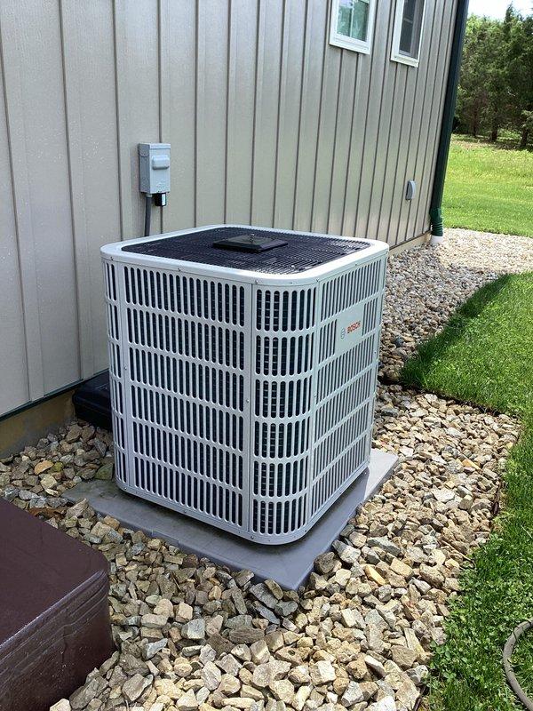 # HVAC Maintenance Report

Responded to service call for garage minisplit system reporting low refrigerant levels. Upon inspection, identified visible signs of refrigerant leak at refrigerant line connections on the outdoor Bosch condenser unit. Documented equipment condition and leak location with photographs for service records. System requires refrigerant line repair and recharge to restore proper cooling operation. Property has three total systems on cooling maintenance plan with renewal date of March 2027; filter sizes need to be determined for future maintenance visits.