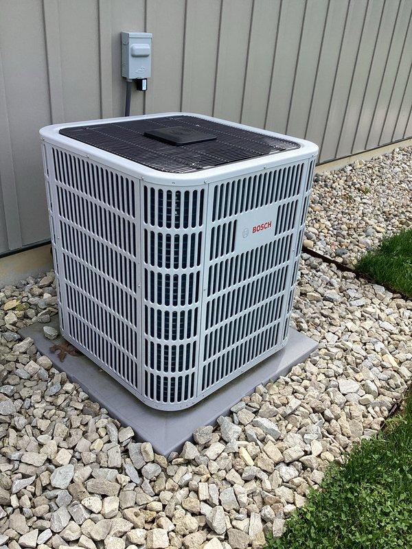 # HVAC Maintenance Report

Responded to service call for garage minisplit system reporting low refrigerant levels. Upon inspection, identified visible signs of refrigerant leak at refrigerant line connections on the outdoor Bosch condenser unit. Documented equipment condition and leak location with photographs for service records. System requires refrigerant line repair and recharge to restore proper cooling operation. Property has three total systems on cooling maintenance plan with renewal date of March 2027; filter sizes need to be determined for future maintenance visits.
