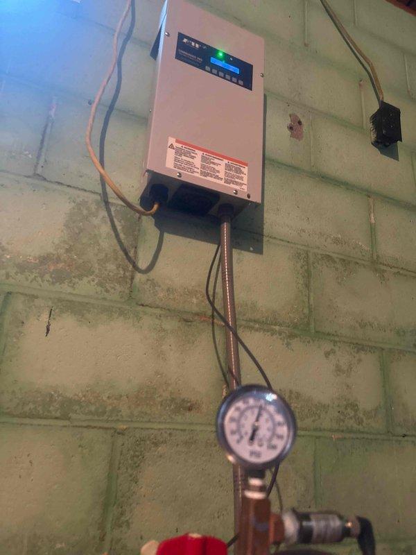 Replaced water line from well to residence following completion of utility locates. Installed new water supply line with proper connections to existing well pump control system and pressure monitoring equipment. System tested and verified operational with appropriate pressure readings displayed on gauge.