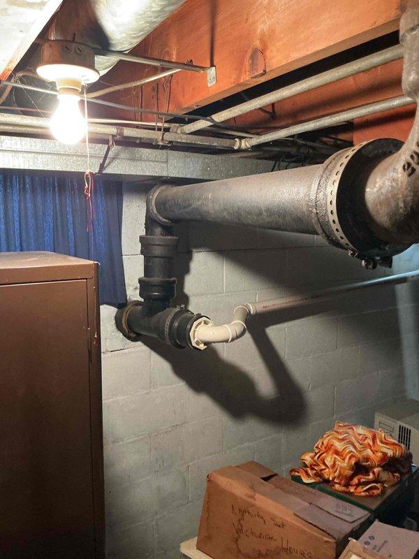 Completed monthly plumbing inspection as part of prepaid maintenance membership. Thoroughly examined basement utility area plumbing systems, including aging cast iron waste lines with flanged connections and vertical supply piping with valve assemblies. Documented condition of existing infrastructure with photographic evidence, noting surface wear and discoloration consistent with system age, with all components currently functioning within normal parameters.