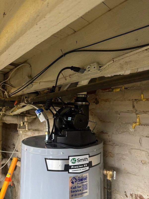 Replaced existing 40-gallon gas power vent water heater with new A.O. Smith ProLine XE model in basement utility area. Installation included power vent blower assembly mounted on top of unit, complete water and gas line connections, and all required safety valves and controls. Customer financed the repair and all necessary documentation was completed and secured on file.