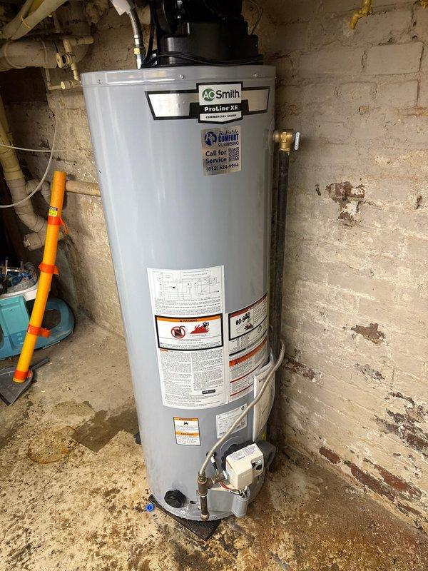 Replaced existing 40-gallon gas power vent water heater with new A.O. Smith ProLine XE model in basement utility area. Installation included power vent blower assembly mounted on top of unit, complete water and gas line connections, and all required safety valves and controls. Customer financed the repair and all necessary documentation was completed and secured on file.