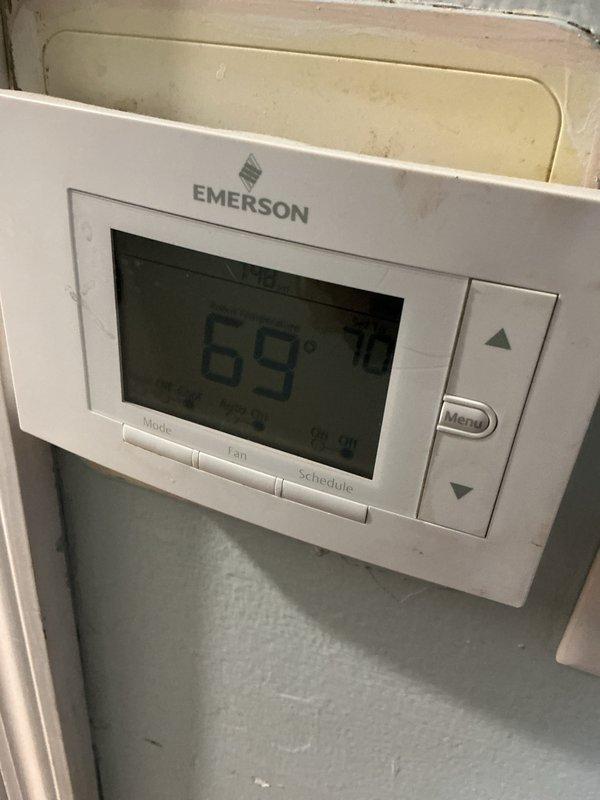 Completed preventive maintenance tune-up on residential HVAC system. Inspected and verified proper operation of Emerson programmable thermostat displaying 69 degrees with functional mode, fan, and schedule controls. Performed comprehensive cleaning and inspection of air handler unit, checking blower motor assembly, internal components, and ventilation systems for proper operation and airflow.