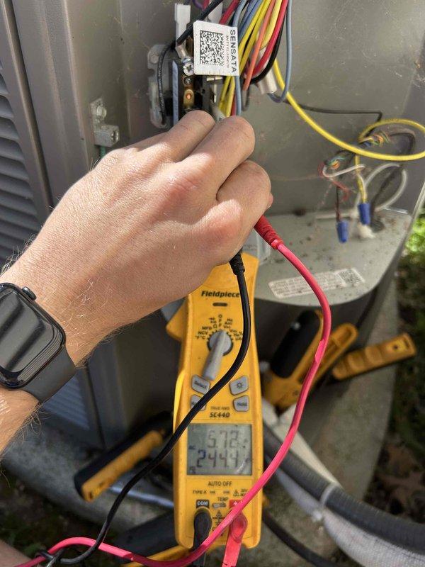 Responded to residential service call for flashing red indicator light on 2-year-old cooling system after filter replacement. Performed diagnostic evaluation of outdoor condensing unit and electrical components. Utilized digital multimeter to test voltage and capacitance readings at control board terminals and run capacitor. Inspected capacitor for proper operation, verified wire connections at terminal blocks, and assessed overall electrical integrity of the system. System operational upon completion of diagnostic testing.