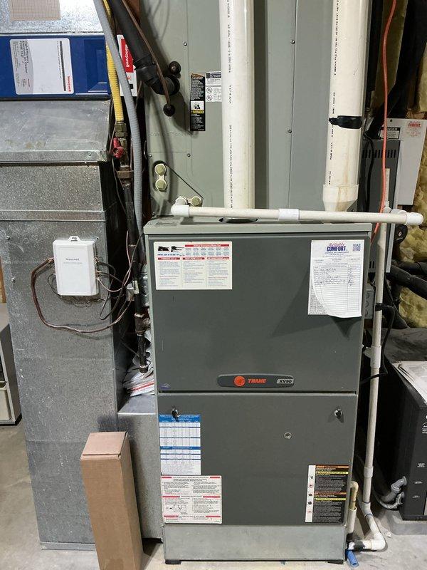 Completed basic monthly cooling maintenance on Trane HVAC system. Inspected evaporator coil and found significant dirt accumulation, debris buildup, and green discoloration indicating mold or algae growth on coil fins. Documented system condition with photos showing dirty coil requiring cleaning, verified all electrical connections and wiring secure, and confirmed proper operation of furnace and cooling components.