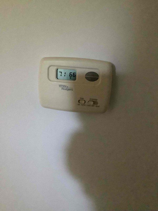Responded to complaint of AC not keeping up and insufficient cooling on older unit. Performed diagnostic evaluation of system, checked thermostat operation showing 71°F setpoint with 66°F indoor temperature, and connected manifold gauges to assess refrigerant pressures and system performance. Evaluated condenser coil condition and overall system operation to determine viability of repair versus replacement.
