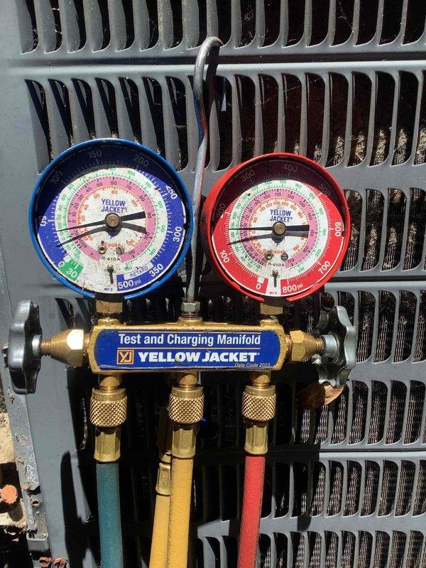 Responded to complaint of AC not keeping up and insufficient cooling on older unit. Performed diagnostic evaluation of system, checked thermostat operation showing 71°F setpoint with 66°F indoor temperature, and connected manifold gauges to assess refrigerant pressures and system performance. Evaluated condenser coil condition and overall system operation to determine viability of repair versus replacement.