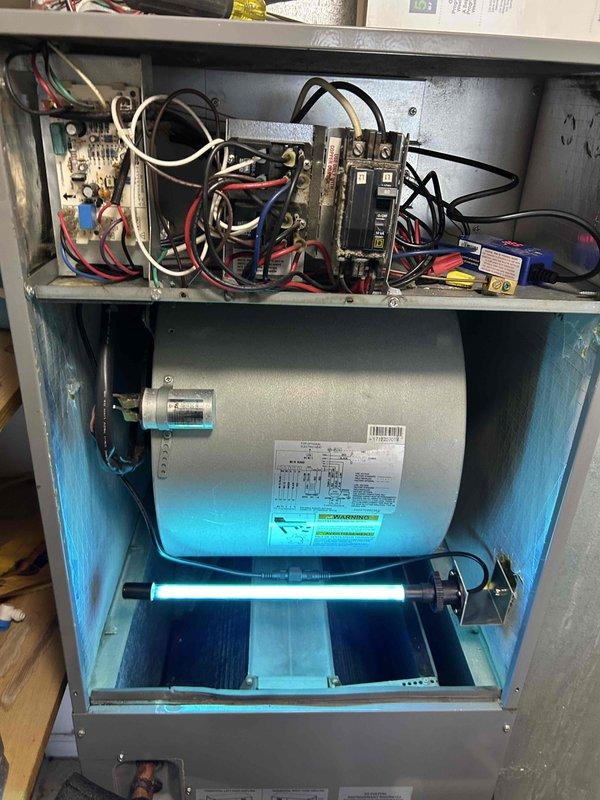 Responded to residential no airflow complaint on air handler unit. Upon arrival, performed diagnostic inspection of indoor HVAC system. Removed access panel to evaluate internal components including blower assembly, control board, and electrical connections. Inspected circuit board, capacitor, wiring harness, and breaker panel within upper control compartment. Examined blower motor assembly and UV light system in lower chamber. All electrical connections verified secure with proper wire routing throughout control panel. System components found in operational condition with no visible damage to circuit board or capacitor. Airflow issue resolved and unit returned to normal operation.