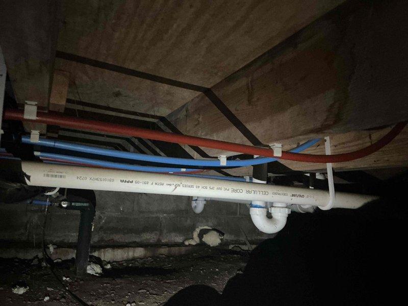 Completed comprehensive whole home plumbing inspection including crawl space and interior utility areas. Examined all accessible supply lines, drainage systems, and appliance connections, documenting conditions with photographic evidence. Verified proper installation of PVC drainage, color-coded water supply lines (hot and cold), and washing machine hookup components including shut-off valves, flexible supply hoses, and drain trap assembly; all systems found to be functioning within normal parameters with no immediate repairs required.