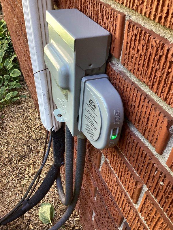 Attempted installation of surge protector at outdoor HVAC disconnect location but encountered seized screws on existing disconnect box that prevented access to electrical connections. Unable to remove disconnect cover due to corroded or overtightened fasteners. Recommended and sold replacement disconnect box to complete surge protector installation, with return visit scheduled to install new disconnect and finish surge protector hookup.