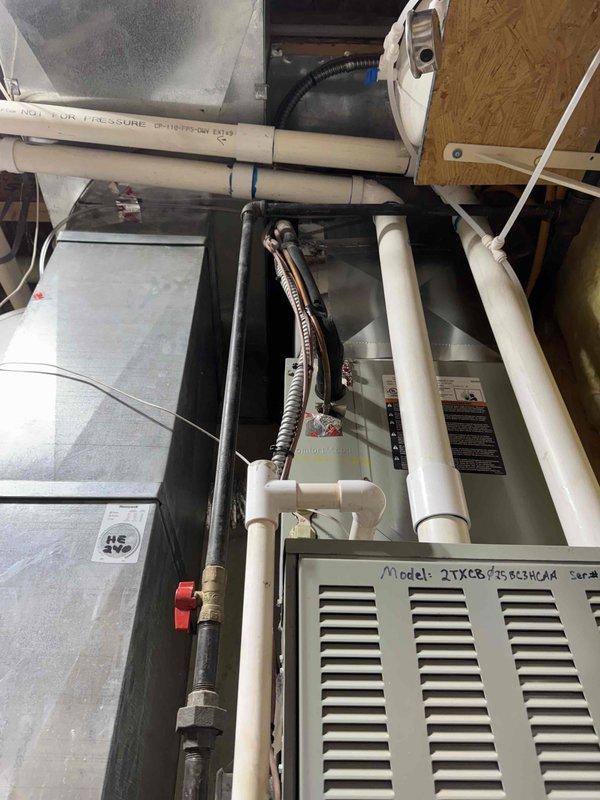 Completed comprehensive duct, blower, and evaporator coil cleaning for both HVAC systems in residence. Accessed attic-mounted unit (Model 27XCS758GE3XROA) and basement-mounted system with Honeywell air handler to perform thorough cleaning of all components. Installed 4-inch media filters on both systems to improve indoor air quality and system efficiency. Verified proper condensate drainage, inspected refrigerant lines and gas connections, and confirmed all ductwork connections were secure following cleaning procedures. Both systems tested and operational upon completion.