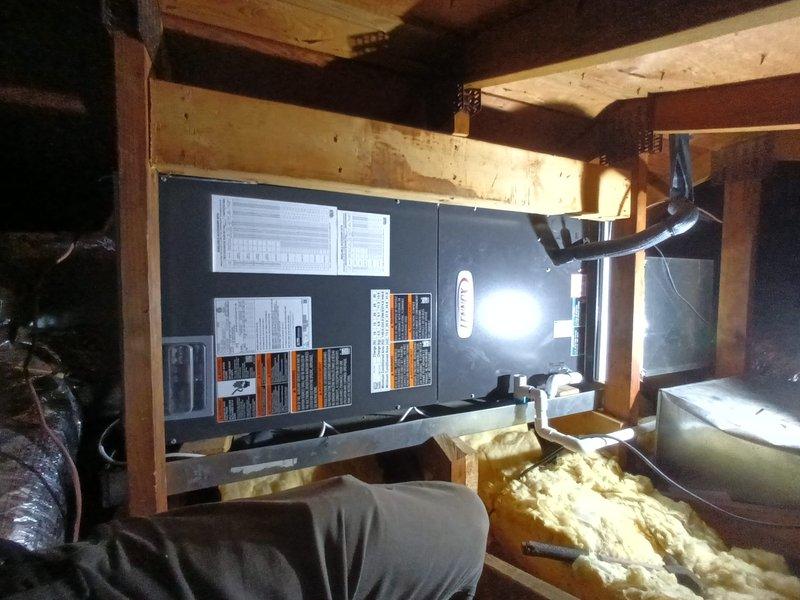 Completed full Lennox heat pump system installation in attic space, including all equipment mounting, electrical connections, and ductwork integration. Verified system operation with temperature readings confirming proper airflow at 74°F, and documented installation with photos showing equipment placement, insulation work, and final system configuration.