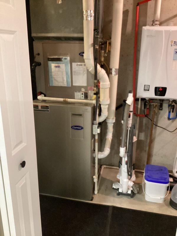 # HVAC Maintenance Summary

Completed basic monthly cooling maintenance visit on Carrier air handler system. Performed standard inspection of unit, verified operational status of all components, and checked system performance. Standard 20x25x4 filter was not included in this service visit per service agreement specifications. All equipment found operating within normal parameters with no immediate concerns identified.

# Detailed Service Report

Performed routine monthly cooling maintenance on residential Carrier HVAC system located in utility room. Conducted comprehensive visual inspection of air handler unit and associated mechanical equipment. Verified proper operation of all accessible components including electrical connections, refrigerant lines, and condensate drainage system.

Inspected white PVC condensate drain lines for proper flow and absence of blockages. Examined all visible copper refrigerant lines and brass fittings for signs of wear, corrosion, or refrigerant leaks. Co