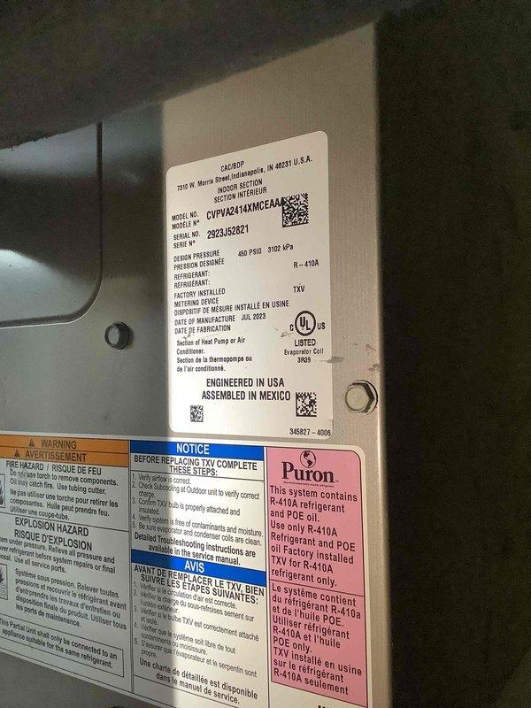 Responded to no-cooling complaint on 2-year-old Carrier CVPH42414XMCAA heat pump system utilizing R-410A refrigerant. Performed diagnostic evaluation following previous service attempt by another contractor. Verified thermostat operation at Black+Decker digital control showing 76°F display with proper power and communication to system. Inspected outdoor unit specifications and confirmed proper model identification, refrigerant type, and TXV configuration per manufacturer labeling.
