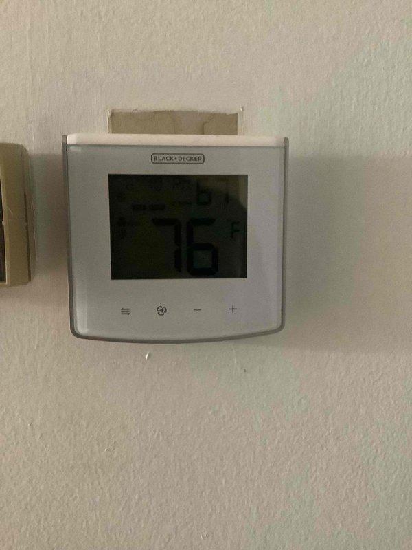 Responded to no-cooling complaint on 2-year-old Carrier CVPH42414XMCAA heat pump system utilizing R-410A refrigerant. Performed diagnostic evaluation following previous service attempt by another contractor. Verified thermostat operation at Black+Decker digital control showing 76°F display with proper power and communication to system. Inspected outdoor unit specifications and confirmed proper model identification, refrigerant type, and TXV configuration per manufacturer labeling.