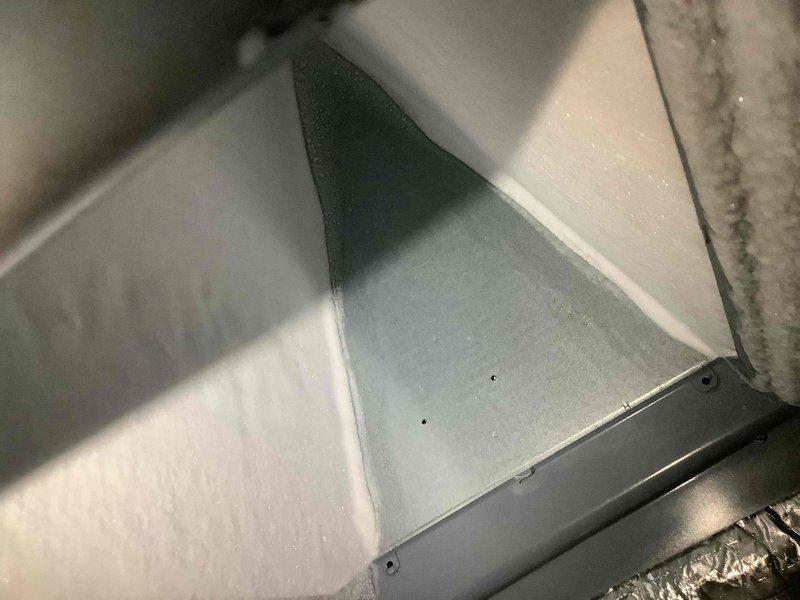 Returned to address ongoing cooling deficiency and excessive noise complaint following previous service visit. Upon arrival, verified thermostat set at 71°F with actual indoor temperature reading 74°F, confirming inadequate cooling performance. Inspected air handler interior and return air grille, noting accumulated debris and dust buildup on grille surfaces that may be restricting airflow. Documented interior components and flex duct connections for further diagnostic evaluation. System continues to exhibit excessive operational noise that has persisted since February, requiring additional troubleshooting to identify source of acoustic issue and resolve temperature control problem.