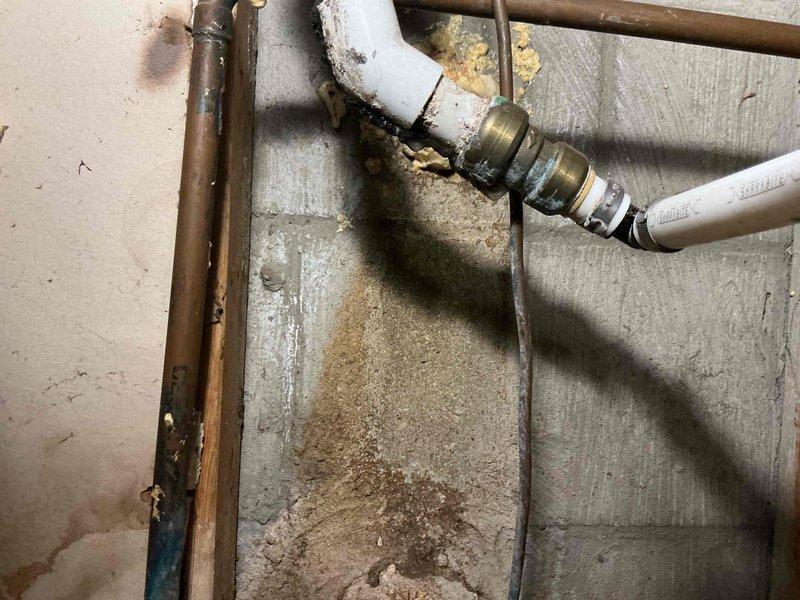Conducted comprehensive assessment of existing sump pump system and associated plumbing infrastructure in basement utility area. Evaluated current pump operation, discharge piping configuration, and overall system condition. Inspected aging copper and metal piping showing oxidation and wear, along with PVC discharge lines. Noted sediment accumulation near pipe connections and evidence of previous moisture issues on concrete surfaces. Assessed backup pump requirements and electrical connections. Provided detailed estimate for sump pump replacement, including primary and backup pump options, new discharge piping, check valve installation, and proper venting to ensure reliable basement water management and flood prevention.