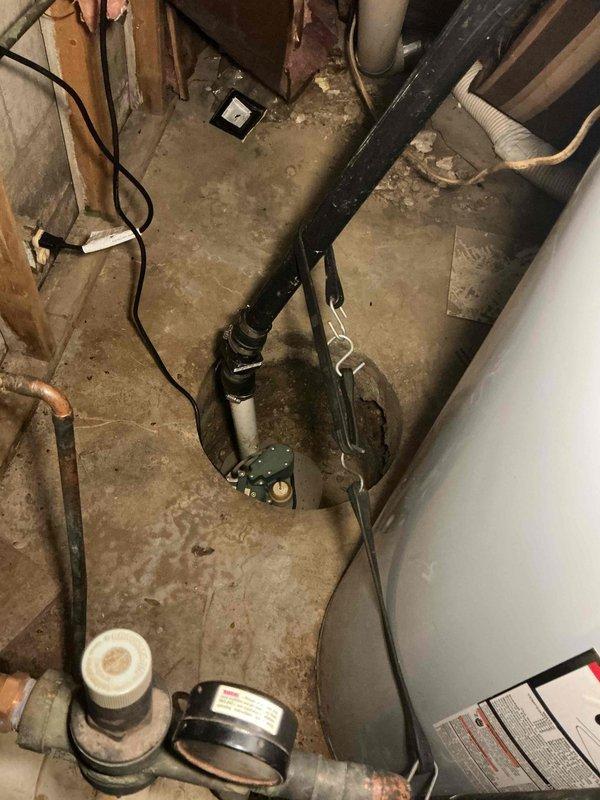 Conducted comprehensive assessment of existing sump pump system and associated plumbing infrastructure in basement utility area. Evaluated current pump operation, discharge piping configuration, and overall system condition. Inspected aging copper and metal piping showing oxidation and wear, along with PVC discharge lines. Noted sediment accumulation near pipe connections and evidence of previous moisture issues on concrete surfaces. Assessed backup pump requirements and electrical connections. Provided detailed estimate for sump pump replacement, including primary and backup pump options, new discharge piping, check valve installation, and proper venting to ensure reliable basement water management and flood prevention.