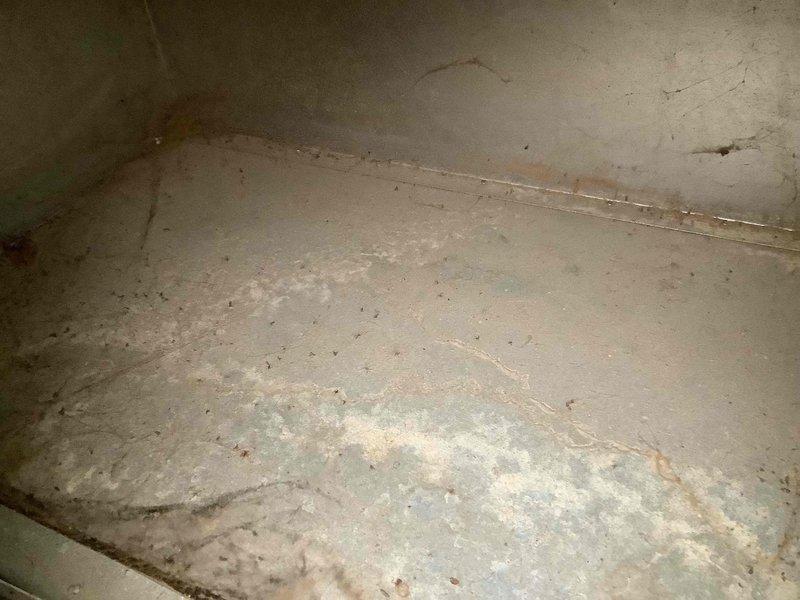 Responded to water leak complaint at basement indoor unit. Upon inspection, found evidence of condensate drainage issue with significant moisture accumulation on concrete floor showing efflorescence and mineral deposits. Performed diagnostic testing on outdoor Bosch condenser unit using multimeter to verify system operation and identify root cause of water leak. Documented moisture damage and system conditions for further evaluation and corrective action.