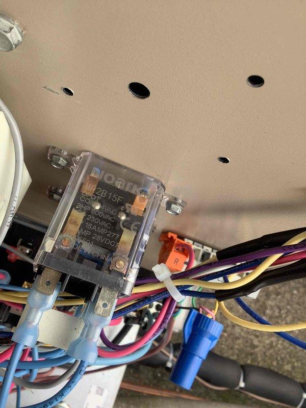 Responded to commercial HVAC service call to diagnose and repair refrigerant leak and troubleshoot circuit 2 failure. Upon arrival, inspected electrical control panel and relay assembly, documenting existing wiring configuration and control module condition. Coordinated with technical support to diagnose circuit 2 operational issues, identifying potential relay or control board malfunction. Performed leak detection procedures on refrigerant system to locate source of leak. Inspected and photographed MECO relay component and associated wiring harness, noting multiple wire connections and proper mounting. Assessed electrical connections, wire terminations, and control circuit integrity throughout equipment panel. System required further diagnostic work and parts procurement to complete repairs on both refrigerant leak and circuit 2 functionality.