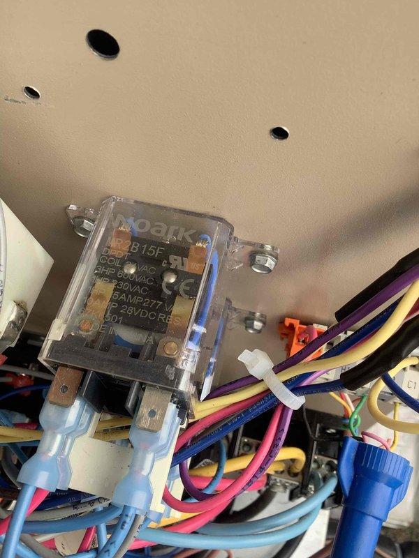 Responded to commercial HVAC service call to diagnose and repair refrigerant leak and troubleshoot circuit 2 failure. Upon arrival, inspected electrical control panel and relay assembly, documenting existing wiring configuration and control module condition. Coordinated with technical support to diagnose circuit 2 operational issues, identifying potential relay or control board malfunction. Performed leak detection procedures on refrigerant system to locate source of leak. Inspected and photographed MECO relay component and associated wiring harness, noting multiple wire connections and proper mounting. Assessed electrical connections, wire terminations, and control circuit integrity throughout equipment panel. System required further diagnostic work and parts procurement to complete repairs on both refrigerant leak and circuit 2 functionality.