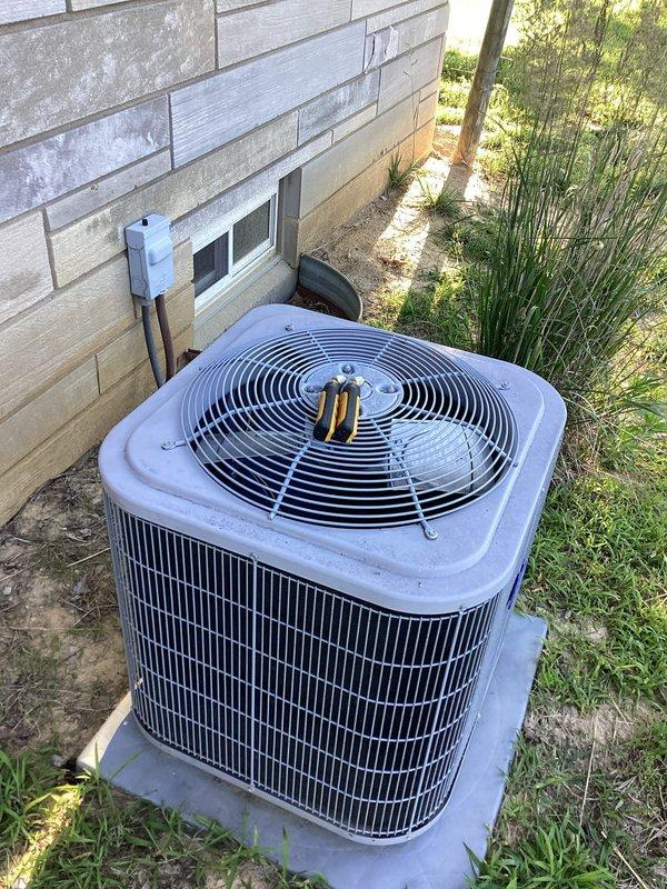Responded to service call for Carrier air conditioning system with reported A-coil refrigerant leak, previously identified during last year's service when system was found low on refrigerant. Performed on-site inspection of outdoor condensing unit and documented equipment condition with photographs for service records.