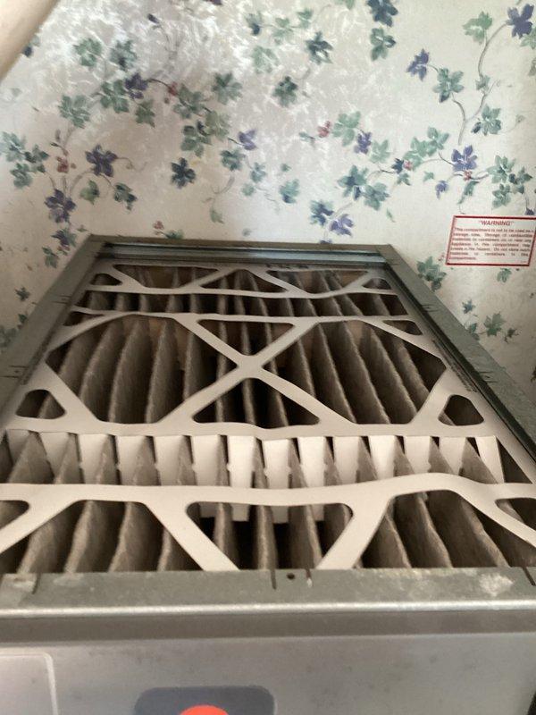 Completed basic monthly cooling maintenance visit on residential HVAC system. Inspected thermostat operation showing proper display function with cooling mode active and temperature differential between setpoint and ambient readings. Documented existing air filtration system with two stacked filters measuring 16x25x4 showing significant dust accumulation and discoloration, indicating filters are due for replacement by customer as they are not included in this service agreement.