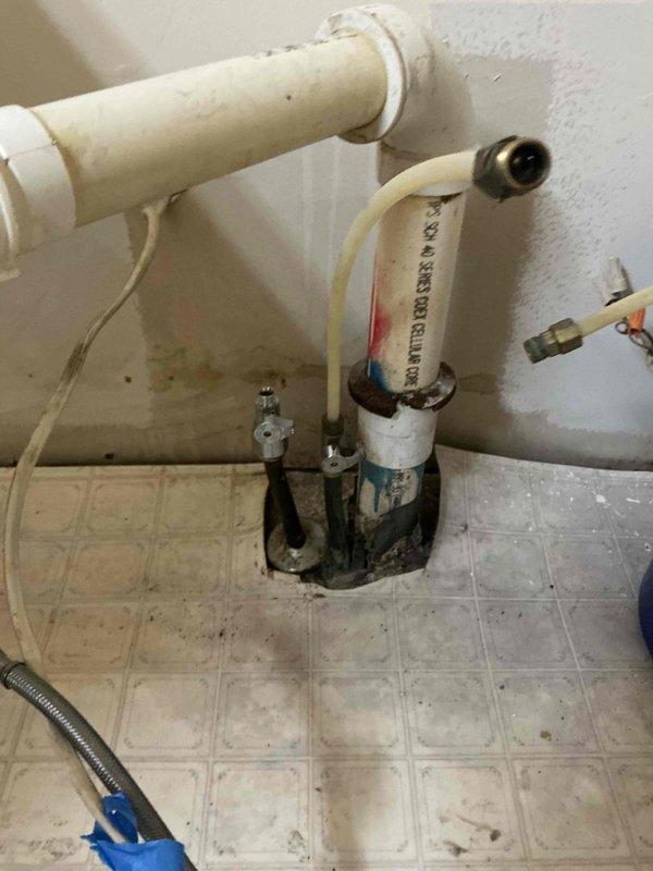 Responded to call regarding leaking hot water shut-off valve beneath bathroom vanity. Upon inspection, discovered significant corrosion and deterioration on the hot water angle stop valve, with visible rust and coating failure causing the leak. Shut off main water supply and replaced the corroded hot water valve with new chrome-plated angle stop. Additionally, per customer request, disconnected plumbing supply lines and removed existing bathroom vanity cabinet to prepare area for future installation.