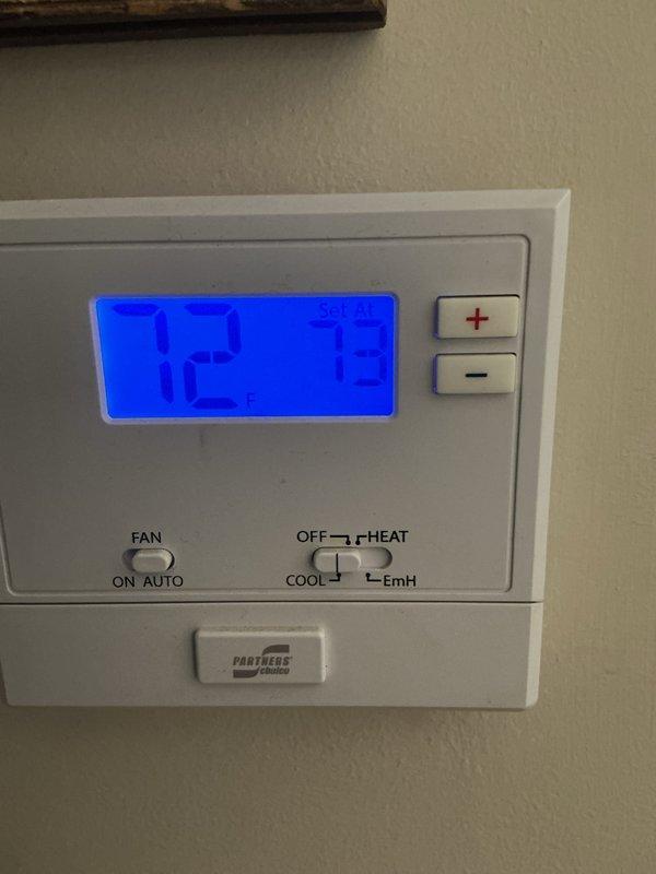 Completed rescheduled cooling system maintenance visit on attic-installed air handler unit with purple Filtrete washable filters in place. Performed basic monthly preventive maintenance inspection, verified refrigerant line connections and copper piping integrity showing normal age-related oxidation, confirmed proper drain pan positioning, and documented system operation with thermostat displaying 82°F at time of service.