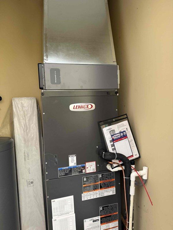 Completed full installation of Lennox heat pump system including indoor air handler and outdoor condensing unit. Indoor unit mounted in mechanical space with proper ductwork connections, electrical wiring, and refrigerant lines installed per manufacturer specifications. Outdoor condenser positioned on concrete pad with gravel base for drainage, connected to indoor unit via refrigerant lineset and electrical disconnect. System commissioned with startup procedures including refrigerant charge verification, airflow testing, thermostat configuration, and full operational testing of heating and cooling modes. All manufacturer labels and warranty documentation verified on equipment, system tested and confirmed operational.