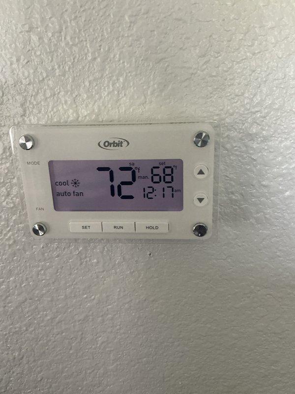 Completed cooling tune-up on residential HVAC system with Trane XE 80 furnace and Orbit digital thermostat. Performed comprehensive maintenance inspection including cleaning condenser coils, checking refrigerant levels, testing electrical connections, verifying proper airflow through ductwork, and confirming thermostat operation displaying 72°F setpoint in cooling mode with auto fan settings. System is operating within manufacturer specifications and ready for the cooling season.