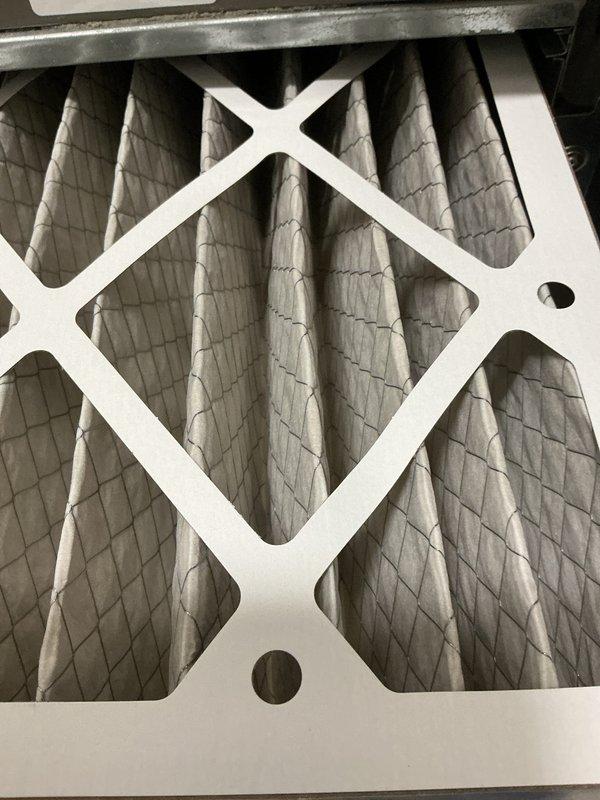 Completed monthly HVAC maintenance service including replacement of 16x20x4 air filter which showed significant dust and debris accumulation. Inspected outdoor condenser unit and confirmed proper operation with clean coils, intact panels, and adequate airflow through louvered vents and top-mounted fan assembly.