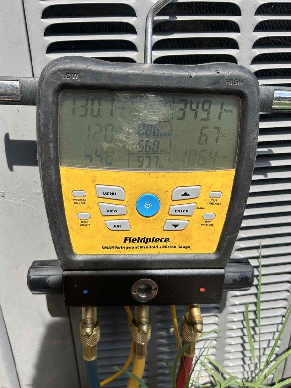 Responded to no cooling complaint on residential A/C unit. Upon arrival, confirmed system was running but not producing cold air with flashing error indicator. Connected refrigerant manifold gauges to outdoor condenser unit and performed diagnostic pressure and temperature readings to assess system performance. Identified cooling system malfunction requiring further troubleshooting of refrigerant charge levels and component operation.