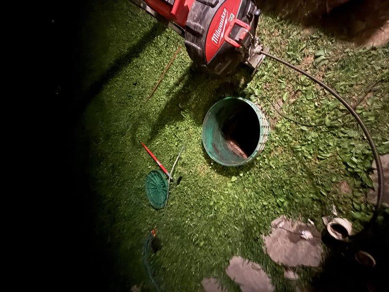 Responded to main drain clog complaint and accessed underground sewer cleanout on property. Utilized power auger equipment to clear blockage in main drain line. Investigation revealed standing water and moisture intrusion in crawlspace area beneath structure, indicating potential drainage issues contributing to the clog. Successfully cleared obstruction and restored proper drainage flow through main sewer line.