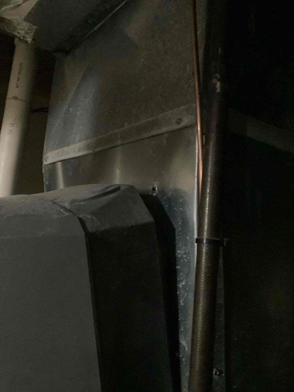 Responded to service call regarding humidifier issue in mechanical room. Upon inspection, found that the whole-house humidifier unit had become detached from its mounting position on the supply ductwork, with the top section leaning forward and no longer properly secured. Repositioned and re-secured the humidifier unit to the ductwork plenum, ensuring proper mounting bracket engagement and stability to prevent future displacement.