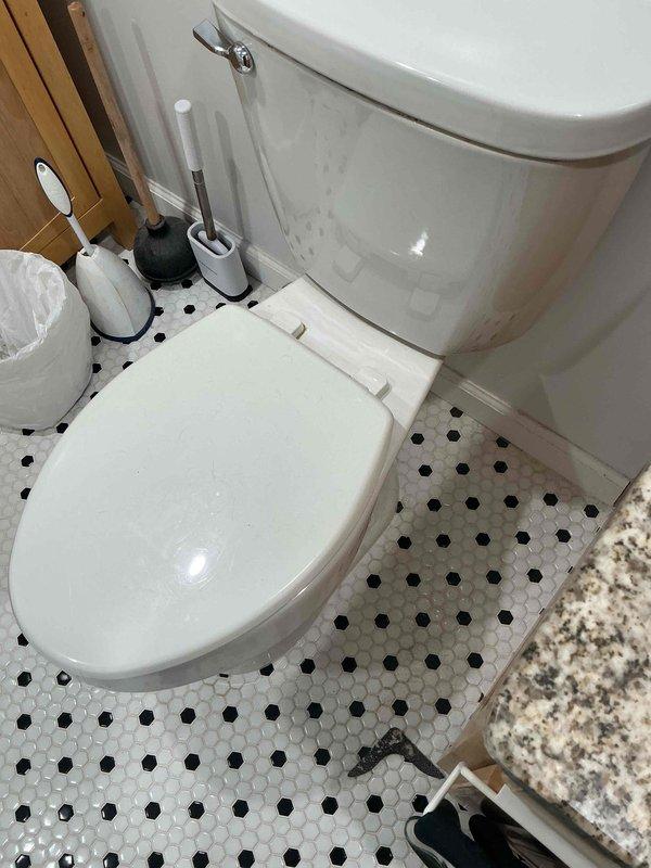 Responded to service call for residential property with three bathrooms experiencing two separate issues: water leak in one bathroom and severe sewage odor in another. Conducted thorough inspection of affected fixtures and surrounding areas. Documented existing conditions with photographic evidence showing standard two-piece toilet installation with hexagonal tile flooring and traditional bathroom layout. Assessed plumbing connections, wax ring seal integrity, and drain line ventilation to identify source of leak and sewage smell. Provided diagnostic findings and recommendations for necessary repairs to resolve both the active water leak and eliminate the persistent sewage odor issue.