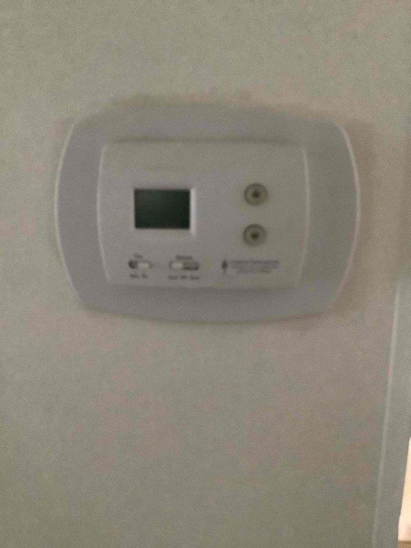 Responded to no-heat call where furnace shut down immediately upon startup and thermostat display went blank during home inspection. Diagnosed electrical issue causing loss of power to thermostat and furnace control board. Inspected outdoor condensing unit and confirmed proper installation on concrete pad with standard electrical connections intact. Troubleshot thermostat wiring and restored power to system, verifying proper communication between thermostat and heating equipment. System tested successfully with furnace cycling normally and thermostat display functioning properly.