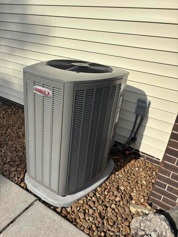 Completed full system installation of Lennox horizontal configuration air conditioning unit and gas furnace. Installed outdoor condensing unit on concrete pad with proper clearances, secured electrical disconnect, and verified system operation with ambient temperature reading of 72°F. Unit positioned with appropriate landscaping rock surround and mounted against building exterior per manufacturer specifications.