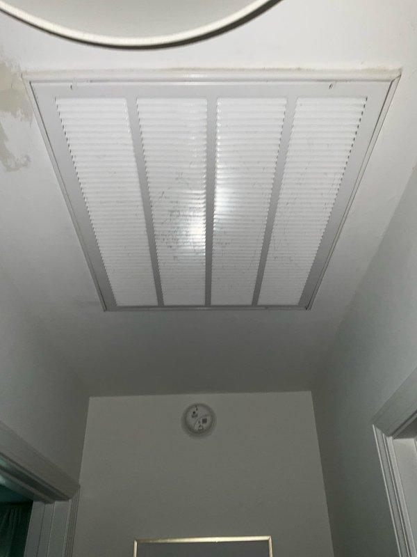 Completed full system replacement estimate for existing R-22 cooling-only system with air handler lacking backup heat capability. Unit was identified as low on refrigerant charge. Assessed ceiling-mounted return air grille and outdoor condensing unit positioned on concrete pad against brick exterior with associated refrigerant lines and electrical connections. Provided comprehensive replacement options for complete HVAC system upgrade to address obsolete R-22 refrigerant and missing auxiliary heat functionality.