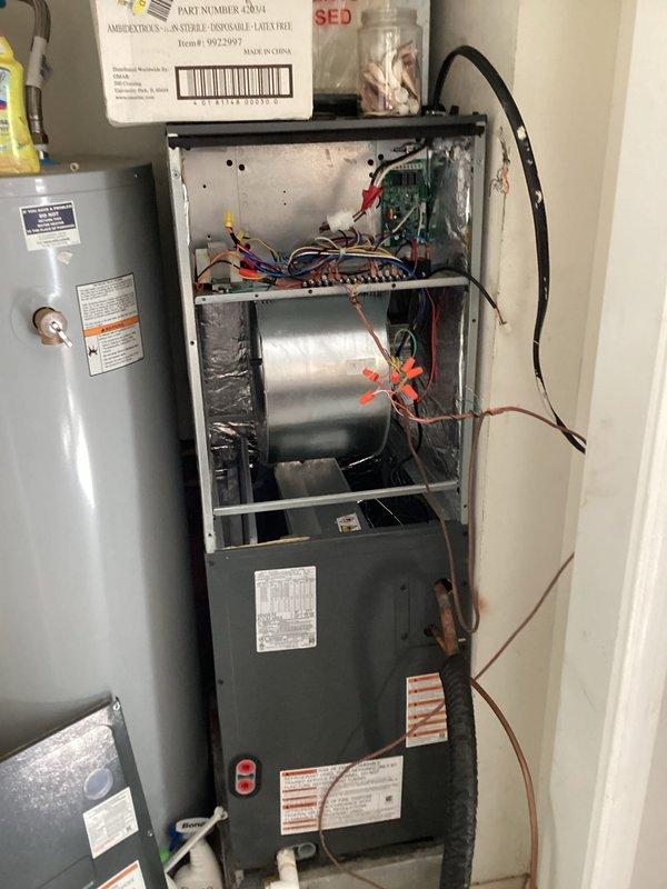 # HVAC Service Call - No Cooling Issue

Responded to no cooling complaint on 10+ year old HVAC system. Upon arrival, performed diagnostic evaluation of heating and cooling equipment. Removed access panel to inspect internal components and electrical connections. Found multiple wiring concerns requiring attention within the unit cabinet. Inspected blower motor assembly, capacitor housing, and control board connections. Examined color-coded wiring including power supply lines and low-voltage control circuits. Verified proper wire terminations at circuit board and component connections. Checked for loose connections, damaged insulation, or signs of overheating on electrical wiring. Evaluated condition of wire nuts and splice connections. Assessed overall system functionality and identified age-related wear on components. Documented equipment condition through photographic evidence showing internal wiring configuration and component layout. Given the age of the system and findings during i